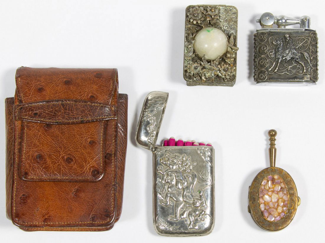 Smoking Accessory Assortment: Smoking Accessory Assortment Including a Nova silver sleeved lighter, a silverplate match box, two portable brass ashtrays and a leather cigarette pack holder Height: 1.75 inches, Width: 1.75 inches,