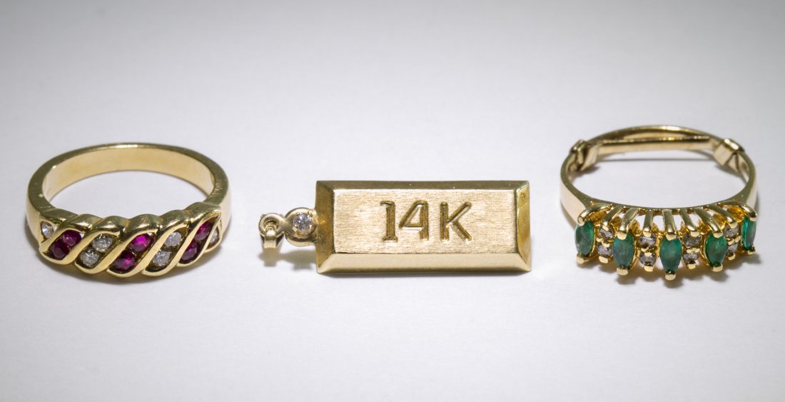 14k Gold Rings: 14k Gold Rings Two rings, one having marquis cut emeralds separated by diamond chips and a sizer bar and the other having round cut rubies separated by diamond chips; together with a pendant in the fo