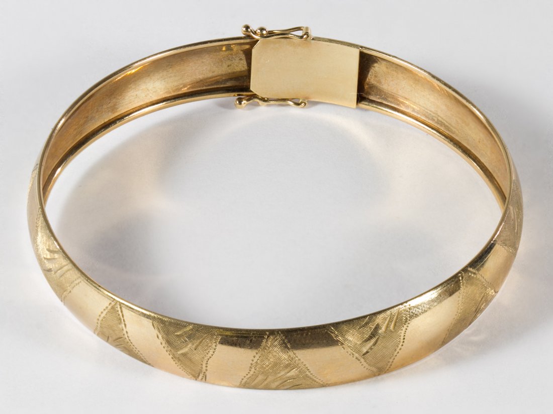 10k Gold Bangle Bracelet and Earrings: 10k Gold Bangle Bracelet and Earrings The bangle having a latch together with three pairs of pieced earrings including chain, hoop and stud having round cut crystals Length: 8.00 inches (inside band) 