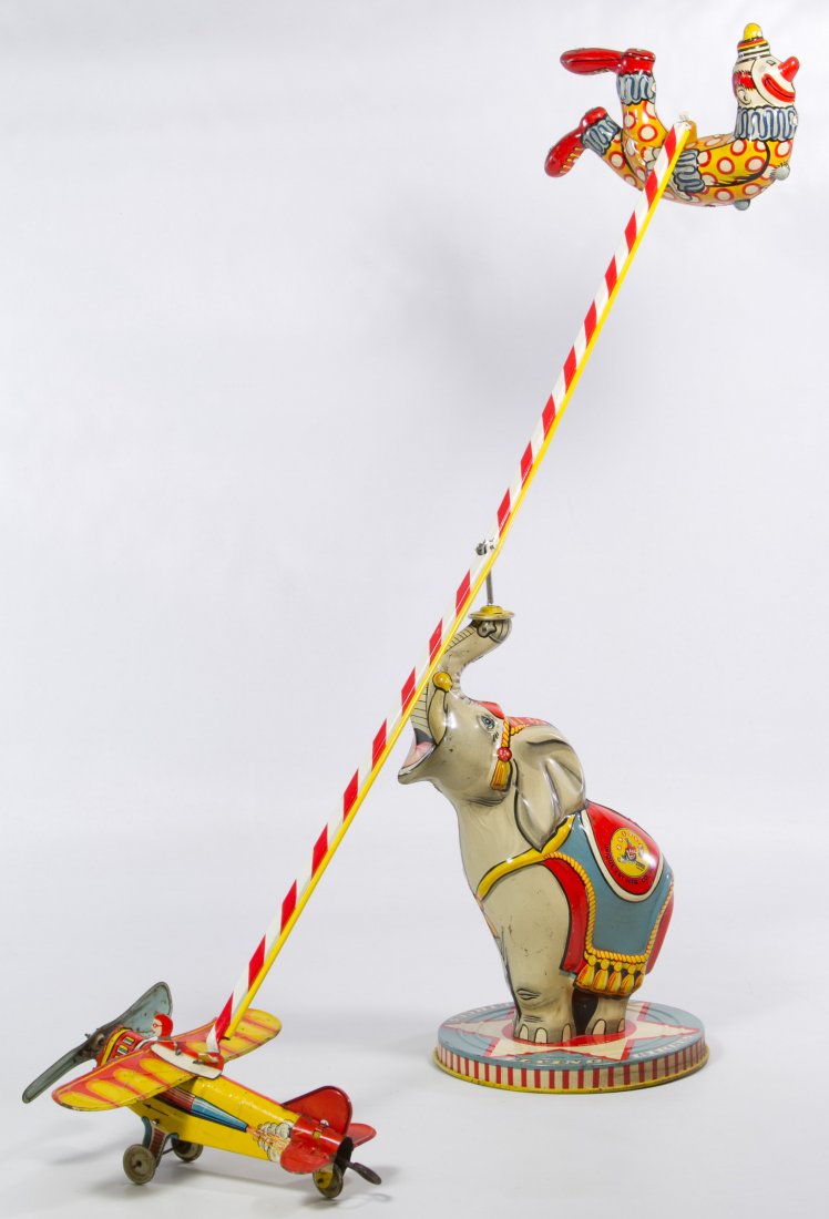 Unique Art 'Flying Circus' Wind-up Tin Toy: Unique Art 'Flying Circus' Wind-up Tin Toy Having an elephant balancing a clown and airplane on a long pole Height: 11.00 inches, Width: 27.00 inches Category: Toys and Dolls > Vintage Toys Shipping S