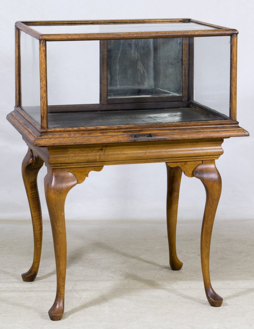 Oak Table Top Display Case on Table: Oak Table Top Display Case on Table Case has glass top, front and sides with sliding mirrored rear doors, on maple table Height: 39.00 inches, Width: 27.00 inches, Depth: 23.00 inches (case on table) 