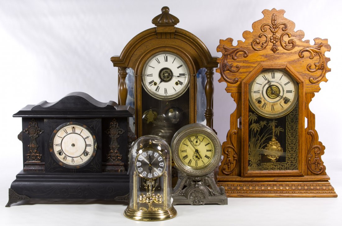 Mantel Clock Assortment: Mantel Clock Assortment Five items including a fruitwood cased clock, an oak cased clock with a painted glass door, a Waterbury black painted clock, a Seth Thomas metal clock and a battery operated Ge