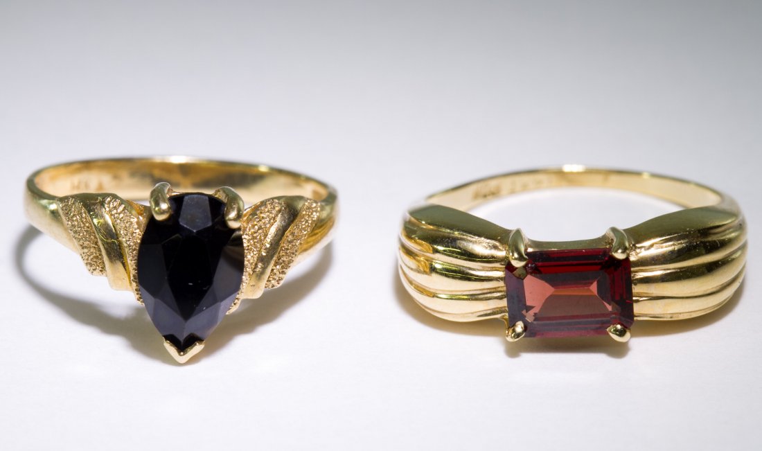 14k Gold and Semi-Precious Gemstone Rings: 14k Gold and Semi-Precious Gemstone Rings Two rings, one having a vertically set rectangular cut garnet, the other having a pear cut onyx Size: 6.5 & 7 Weight: 3.29 dwts. Category: Jewelry & Timepiece