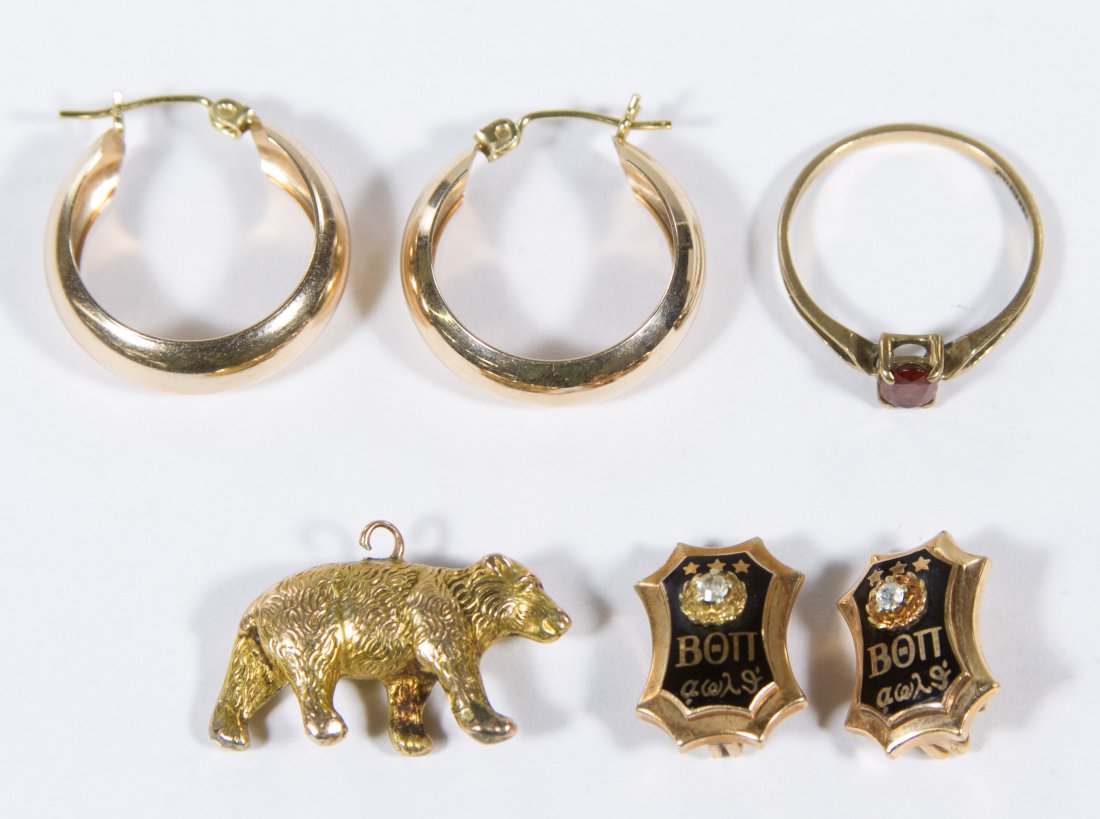 10k Gold Jewelry Assortment: 10k Gold Jewelry Assortment Including a pair of hoop pierced earrings, a ring having an oval cut garnet, a bear charm and two pins from Beta Omega Phi fraternity Length: 1.00 inches (earrings) Size: 6