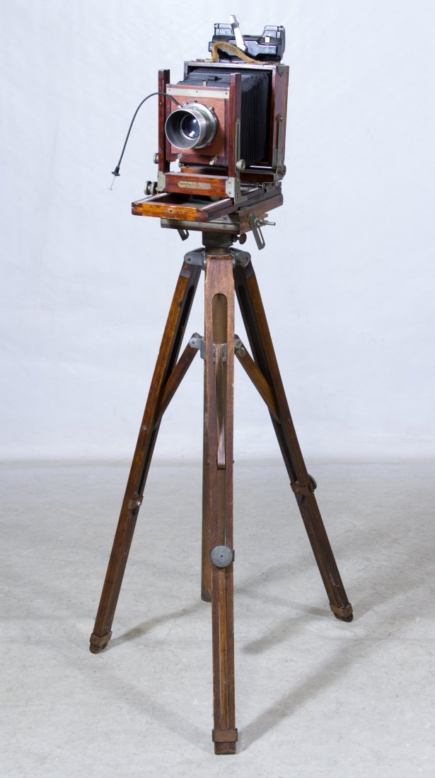 Gundlach Mfg. Co. Bellows Camera: Gundlach Mfg. Co. Bellows Camera Having a Kodak Supermatic Graphic lens; together with a wood tripod, extra Kodak lens, two film loaders, four 4x5 plastic film holders and four 4x5 wood film holders C
