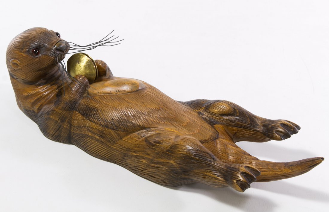 Tom Taber Wood Carved Otter Sculpture: Tom Taber Wood Carved Otter Sculpture 20th Century, having plastic red eyes and metal whiskers, signature to the underside Height: 3.50 inches, Length: 16.50 inches Category: Decorative Arts > Statues