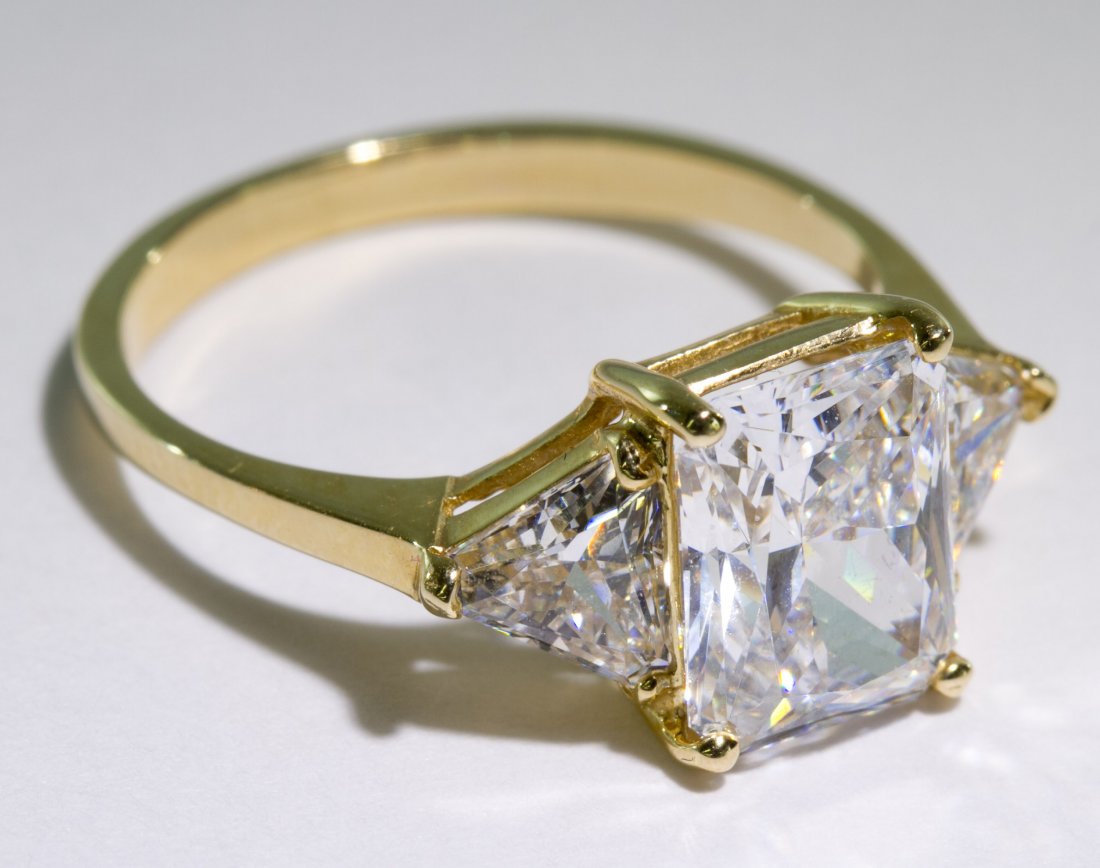 14k Gold and Cubic Zirconia Ring: 14k Gold and Cubic Zirconia Ring Having an emerald cut flanked by trillion cut Size: 7 Weight: 2.19 dwts. (total weight) Category: Jewelry & Timepieces > 14k Gold Shipping Status: Leonard Auction, Inc