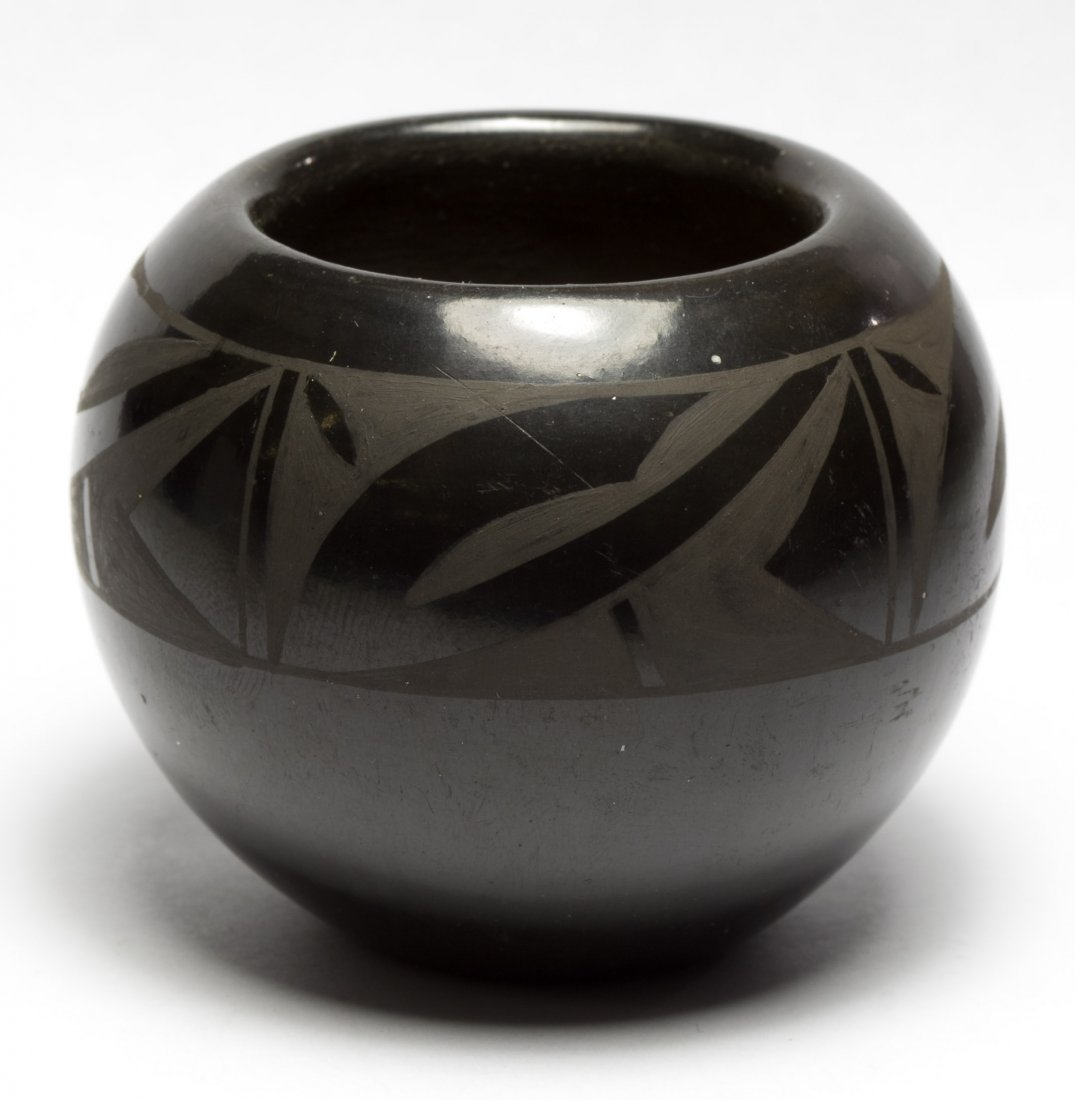 Black Pottery Bowl by Juan Tafoya from San Ildefonso: Black Pottery Bowl by Juan Tafoya from San Ildefonso Pueblo, NM 1992; having a black on black design and signed on the underside Height: 2.00 inches, Width: 2.25 inches Category: Decorative Arts > Eth
