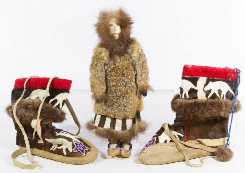 Eskimo Doll and Native American Boots: Eskimo Doll and Native American Boots Two items including a pair of wool, fur applique and beaded star buckskin child size boots and an Eskimo doll with leather face and fur clothes Height: 14.50 inch