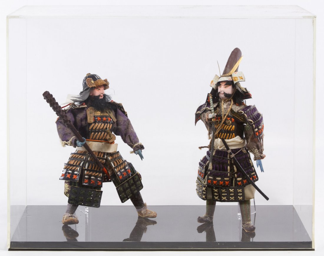 Japanese Samurai Dolls: Japanese Samurai Dolls Two dolls of wood and composition construction with lacquered paper armor; mounted into a display box Height: 9.00 inches Category: Decorative Arts > Asian Shipping Status: Due