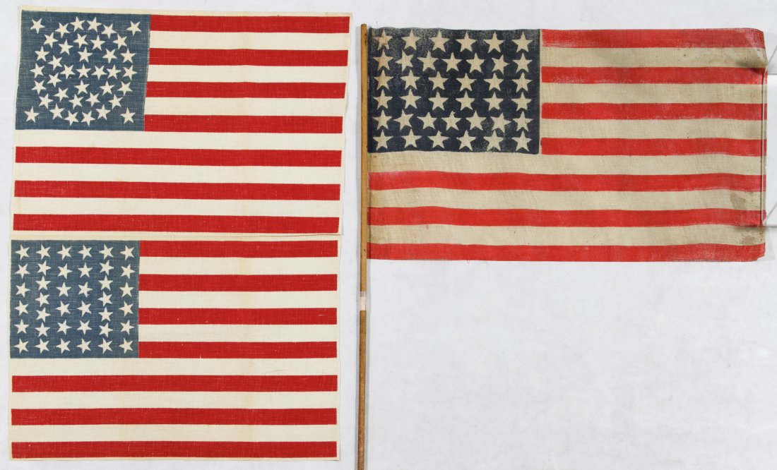 38-Star American Flag Assortment: 38-Star American Flag Assortment c.1877 three printed cotton flags including one on a pole and two on a single sheet with one having a rare triple medallion star field Height: 12.00 inches, Width: 17.