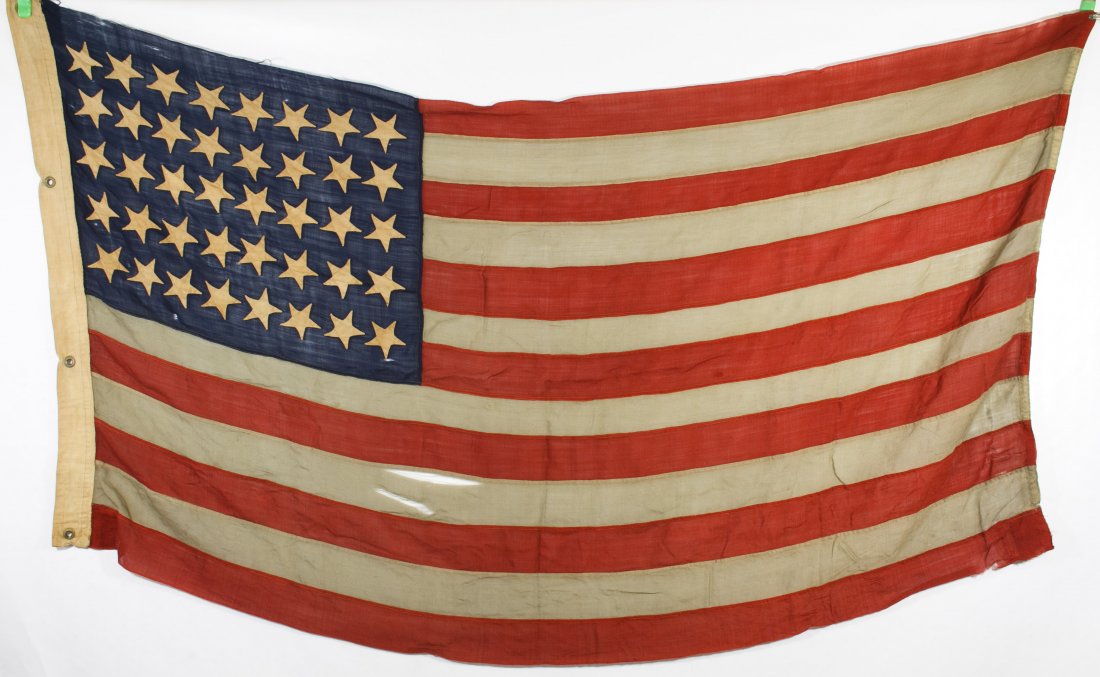 40-Star American Flags: 40-Star American Flags c.1889 two flags including a hand made linen and wool flag with forty appliqued stars and a smaller hand held printed cotton flag Height: 47.00 inches, Length: 89.00 inches (len