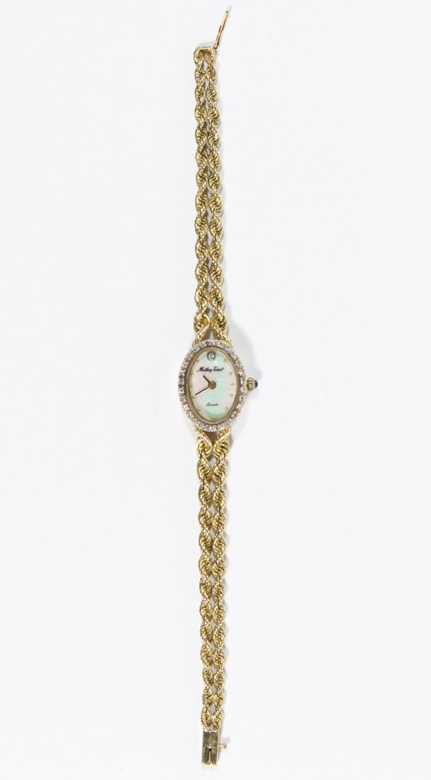 Mathey Tissot 14k Gold Wrist Watch and Band: Mathey Tissot 14k Gold Wrist Watch and Band Having a mother of pearl face encircled with diamond chips and a six jewel Swiss parts quartz movement; watch and band marked 14k Length: 6.13 inches Weight