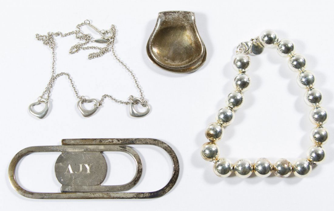 Tiffany and Co Sterling Silver Jewelry Assortment: Tiffany and Co Sterling Silver Jewelry Assortment Four pieces including two pieces by Elsa Peretti designs including the 'Open Heart' necklace and the 'Thumbprint' money clip as well as a bead bracele