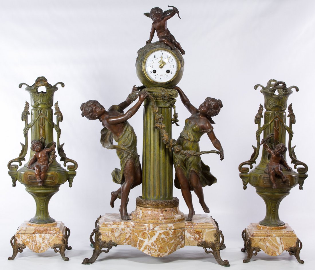 Gilt Metal and Marble French Clock and Garniture Set by: Gilt Metal and Marble French Clock and Garniture Set by Moreau Three items including a Rococo style spelter and marble figural center clock marked 'JS France 61647' en verso of clockworks, a painted m
