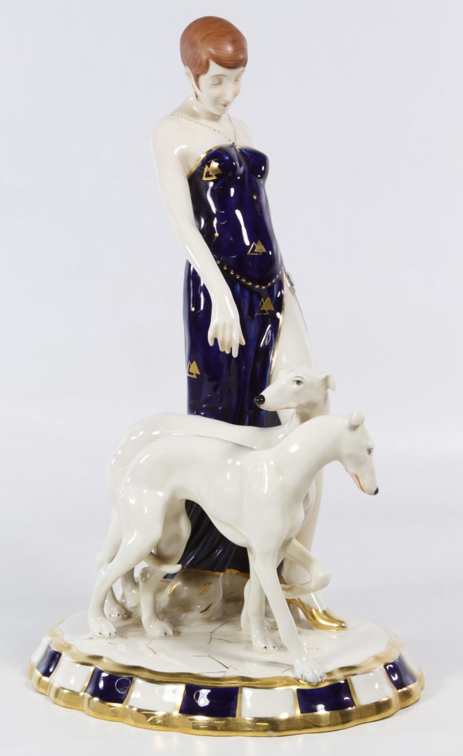 Royal Dux 'Flapper with Borzoi Dogs' Figurine: Royal Dux 'Flapper with Borzoi Dogs' Figurine Having an Art Deco style female figure with two dogs; marked on the underside '304 6' and 'Made in Czechoslovakia' Height: 15.00 inches Category: Figurine