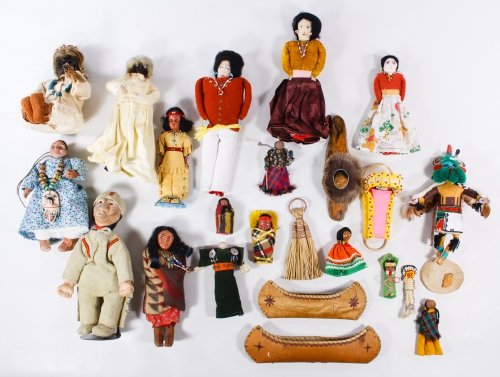 Native American Doll Assortment: Native American Doll Assortment Including composition Skookum, cloth Navajo, beaded Zuni, carved wood Kachina and dried apple head dolls; together with miniature birch bark canoes Height: 11.00 inches