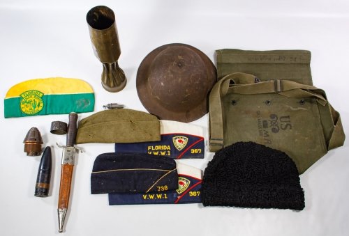 World War I Military Item Assortment: World War I Military Item Assortment Including caps, trench art, dagger, helmet and accessories Height: 13.50 inches (tallest) Category: Military & Weapons > World War I Shipping Status: Leonard Aucti