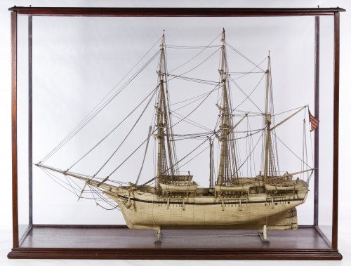 Whale Bone Ship Model with Display Case: Whale Bone Ship Model with Display Case c.1850; constructed of whale bone and modeled on a ship in the fleet of American Jonathan Bourne, Jr.; having an American flag and a 'B' marked red, white and b