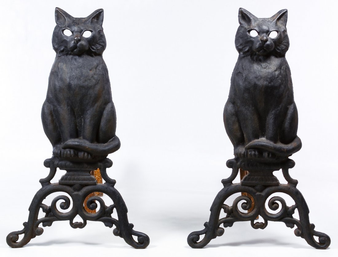 Cast Iron Figural Cat Andirons: Cast Iron Figural Cat Andirons Pair of andirons with seated cat figures on scrolled bases with cut out eyes; unmarked Height: 17.50 inches, Width: 11.00 inches, Depth: 17.50 inches (both) Category: De