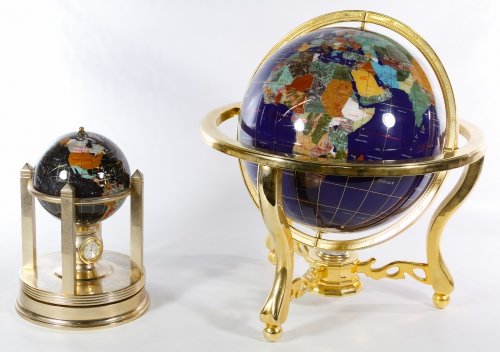 Inlaid Stone World Globes: Inlaid Stone World Globes Two contemporary items with semi-precious gemstone cut countries including a larger globe on a pivoting brass base with an inset compass and a smaller globe with two clocks,