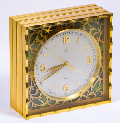 Omega Eight-Day Desk Clock: Omega Eight-Day Desk Clock Having serial #10824197, Swiss twenty jewel movement, brass case and wooden box Height: 5.00 inches, Width: 5.00 inches Category: Decorative Arts > Clocks Shipping Status: L