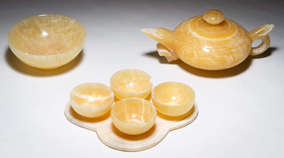 Asian Jadeite Jade Tea Service: Asian Jadeite Jade Tea Service Including a teapot, a trivet, four small cups and a bowl Height: 3.50 inches, Length: 7.50 inches (teapot) Category: Decorative Arts > Asian Shipping Status: Due to size