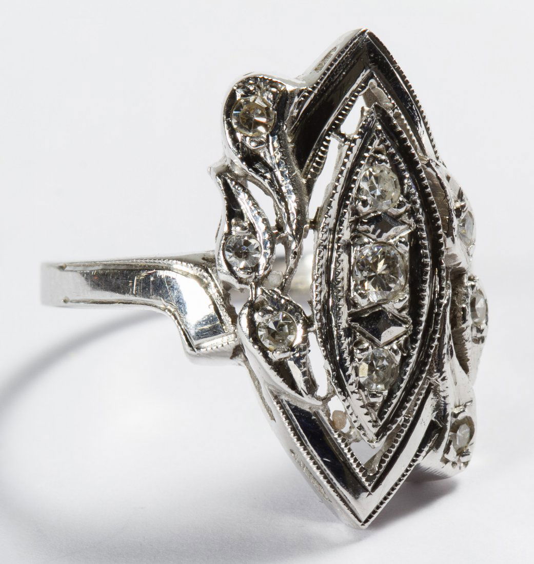 14k White Gold and Diamond Ring: 14k White Gold and Diamond Ring Art Deco style setting having three round cut vertically set diamonds flanked by six diamond chips; marked 14k inside band Size: 4 Weight: 2.15 dwts. (total weight) Cat