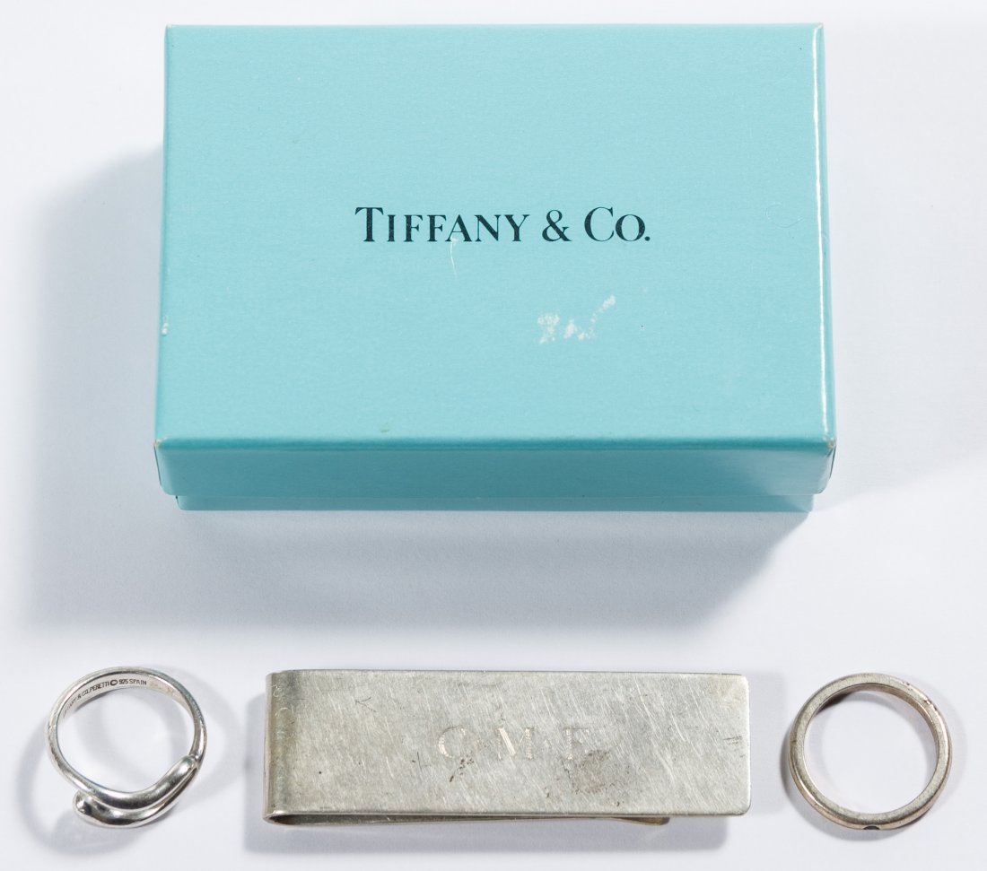 Tiffany & Co Sterling Silver Jewelry Assortment: Tiffany & Co Sterling Silver Jewelry Assortment Including a money clip and two Peretti rings; together with a Tiffany & Co box and bag Length: 2.25 inches Size: 5 & 5.5 Weight: 16.28 dwts. (total weig