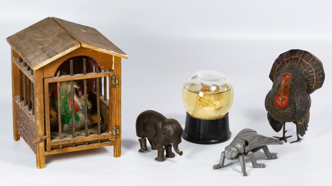 Antique Toy Assortment: Antique Toy Assortment Five items including a papier mache turkey candy container, a metal insect covered box, an Ives cast iron elephant ramp walker, an Atlas Crystal Works snow globe and a German pu
