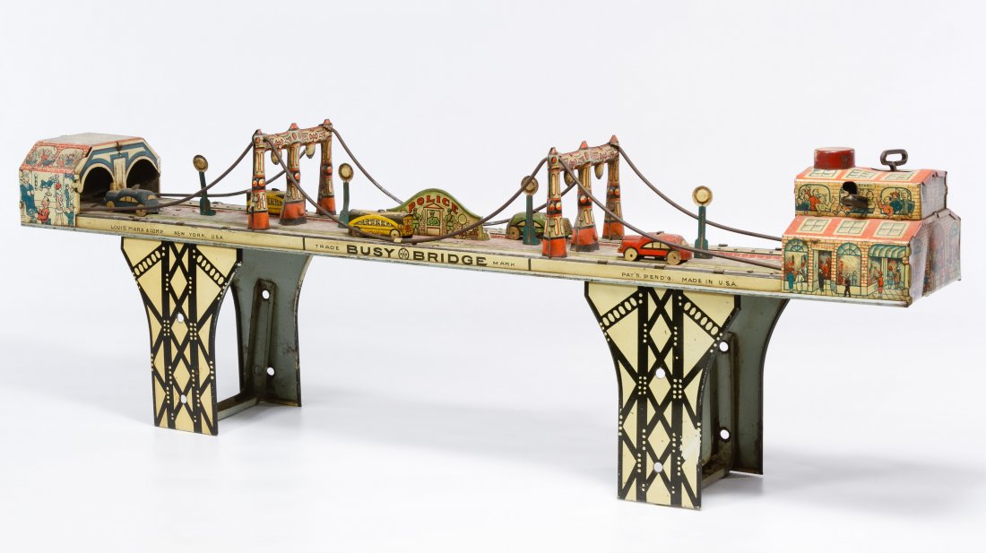 Marx 'Busy Bridge' Wind-up Tin Toy: Marx 'Busy Bridge' Wind-up Tin Toy c.1940, stamped maker mark, having six cars, including key Height: 7.75 inches, Width: 24.00 inches, Depth: 3.50 inches Category: Toys and Dolls > Vintage Toys Shipp