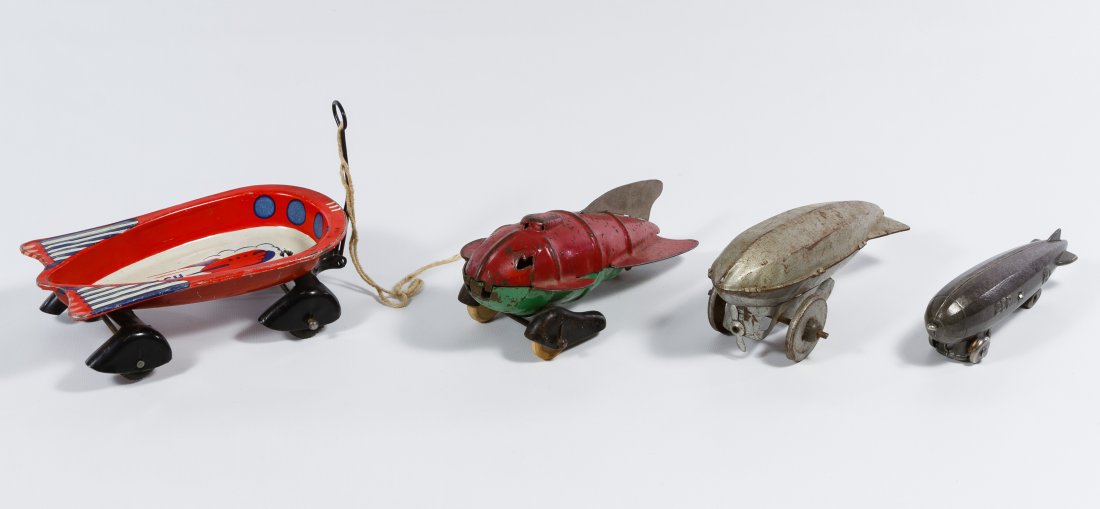 Toy Rocket, Wagon and Zeppelin Assortment: Toy Rocket, Wagon and Zeppelin Assortment Four items including a red and green pressed steel toy rocket with wooden wheels possibly made by Wyandotte, a Wyandotte 'Flash Strat-O-Wagon,' a cast metal '