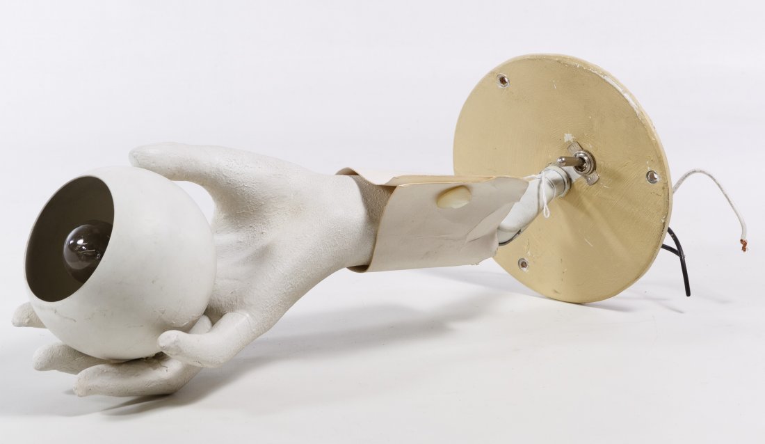 Composition Hand-Form Wall Lamp: Composition Hand-Form Wall Lamp Having a composition and wood painted man's hand with paper cuff and mother of pearl cufflink holding a round globe for an electric bulb on a wood and pivoting metal wa