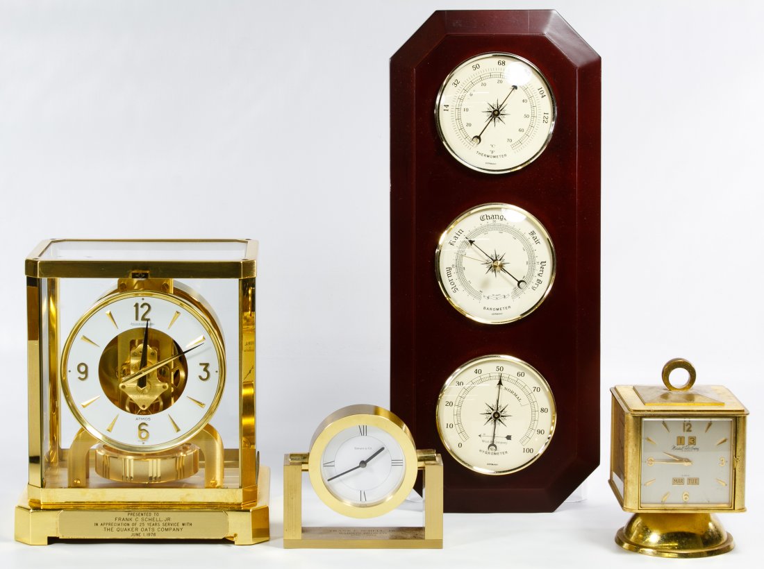 Jaeger LeCoultre Atmos Clock: Jaeger LeCoultre Atmos Clock Having serial #453750 and brass and glass case with name plaque; together with a Marshall Field Company brass barometer clock, a Tiffany & Co. brass table clock and a Germ