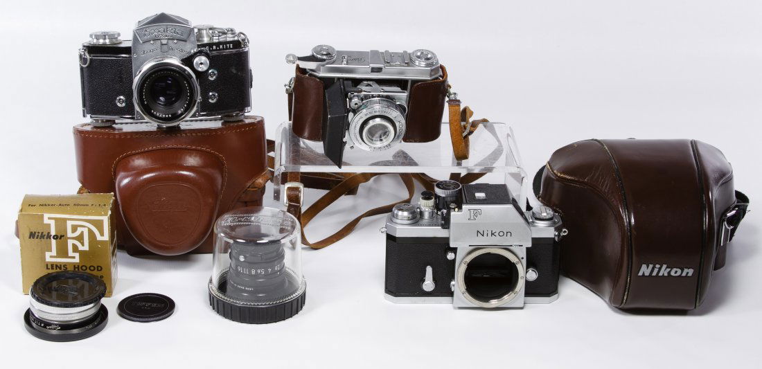 Camera Assortment: Camera Assortment Including a Nikkor CP-2 lens, a Nikkor F lens hood, a Nikon camera #6816344, a Kodak Retina camera and an Exakta VXIIa Jhagee camera with a Tiffen lens Length: 7.00 inches (Nikon) Ca