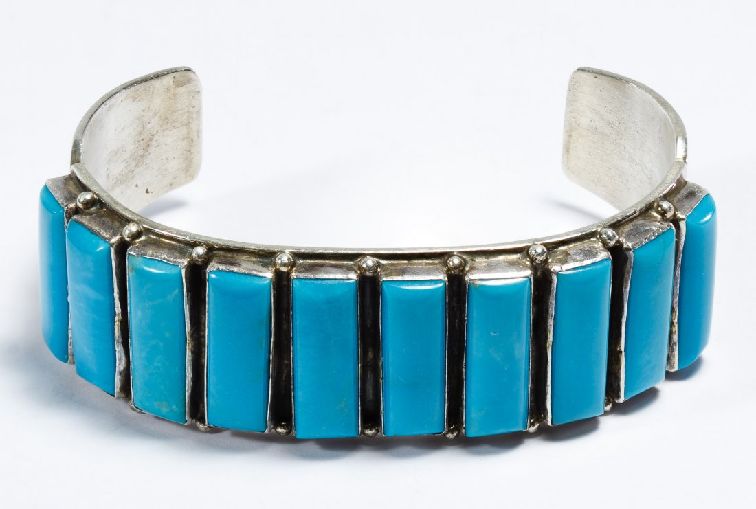 Native American Navajo Sterling Silver Bracelet by C: Native American Navajo Sterling Silver Bracelet by C Jones Cuff bracelet having ten rectangular cut vertically set turquoise bars; signed inside band C. Jones and sterling Length: 7.50 inches (inside 
