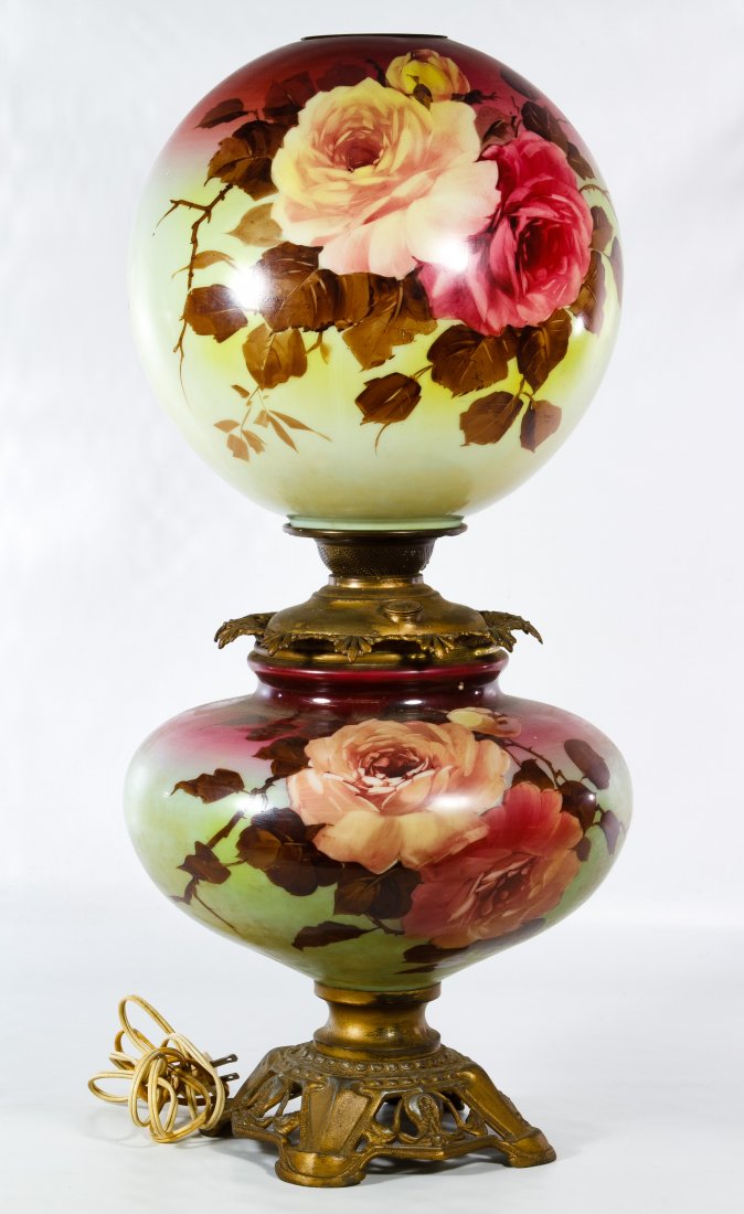 Electrified 'Gone with the Wind' Table Lamp: Electrified 'Gone with the Wind' Table Lamp Having a hand painted rose motif on glass shade and body with a metal base marked 'PL&BCO' Height: 26.50 inches Category: Decorative Arts > Lamps Shipping S