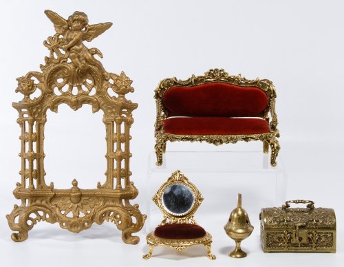 Brass Jewelry Box and Pin Cushion Assortment: Brass Jewelry Box and Pin Cushion Assortment Including a German Rococo style brass jewelry box, a brass bell, two brass and velvet furniture style pin cushions and a cast metal cherub motif picture fr