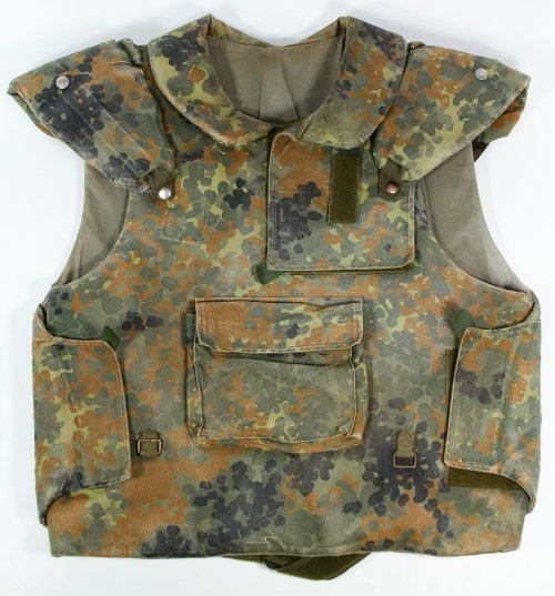 German Military Flak Vest: German Military Flak Vest 1987 production; camouflage exterior and German language label on the interior Height: 24.00 inches, Width: 24.00 inches Category: Military & Weapons > Modern Military Shippi
