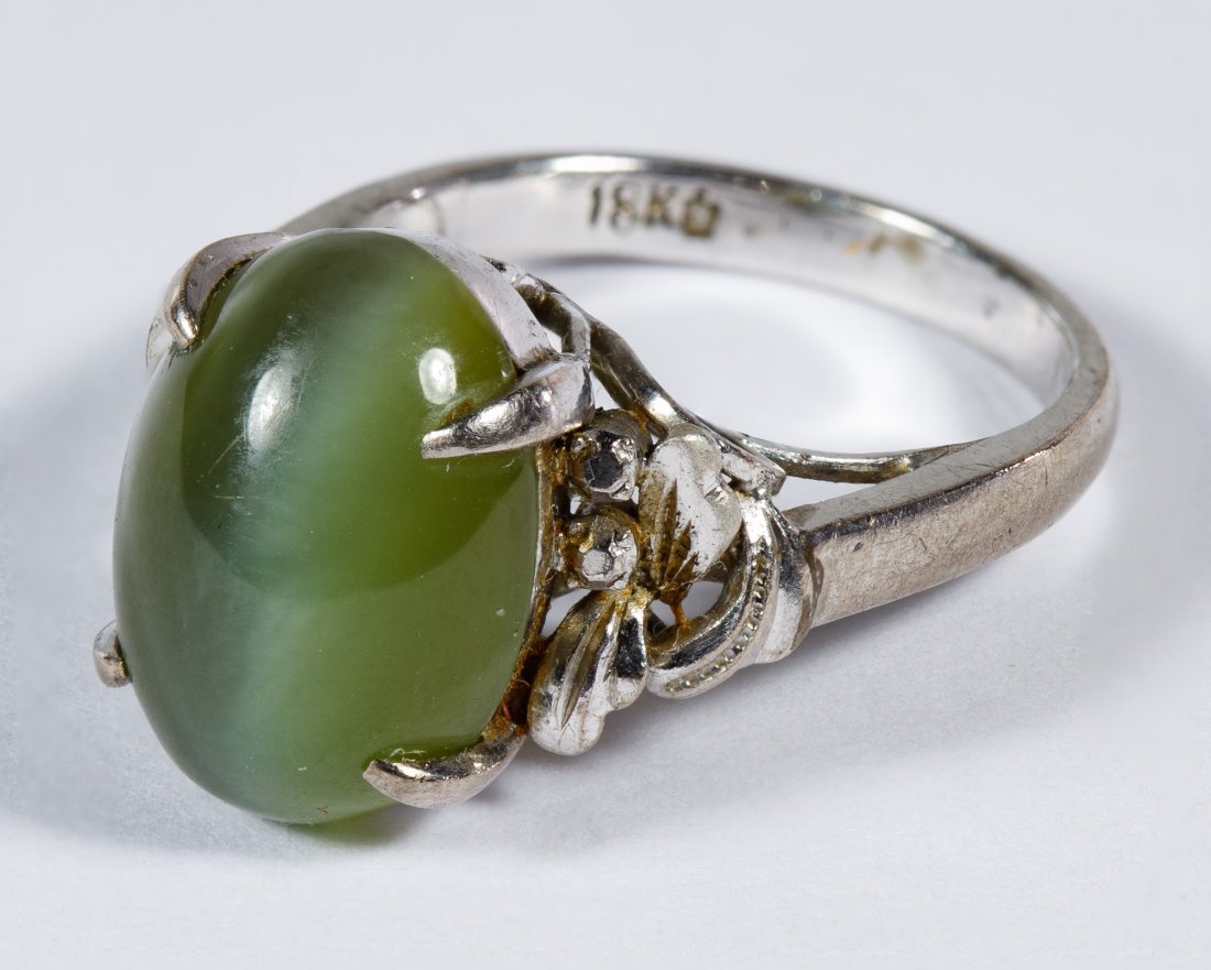 18k White Gold and Green Cat's Eye Ring: 18k White Gold and Green Cat's Eye Ring Having a 13mm by 9mm oval cut gemstone; marked 14k inside band Size: 5.5 Weight: 3.14 dwts. (total weight) Category: Jewelry & Timepieces > 18k Gold Shipping St