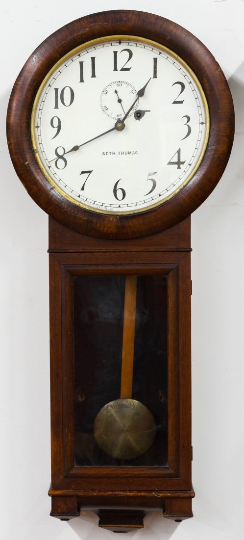 Mahogany Seth Thomas Wall Clock: Mahogany Seth Thomas Wall Clock Having the weights, pendulum and key Height: 37.00 inches, Width: 15.50 inches, Depth: 5.00 inches Category: Decorative Arts > Clocks Shipping Status: Due to size, weig