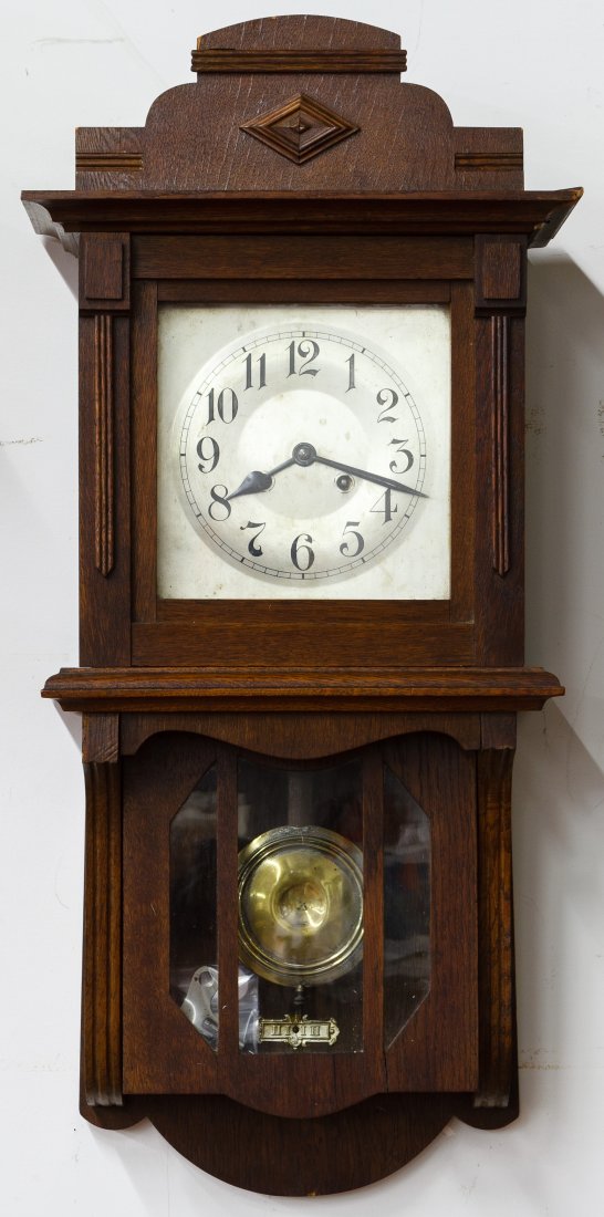 Mahogany Wall Clock: Mahogany Wall Clock Having the key and pendulum, metal dial and side doors Height: 32.50 inches, Width: 14.75 inches, Depth: 8.00 inches Category: Decorative Arts > Clocks Shipping Status: Due to size