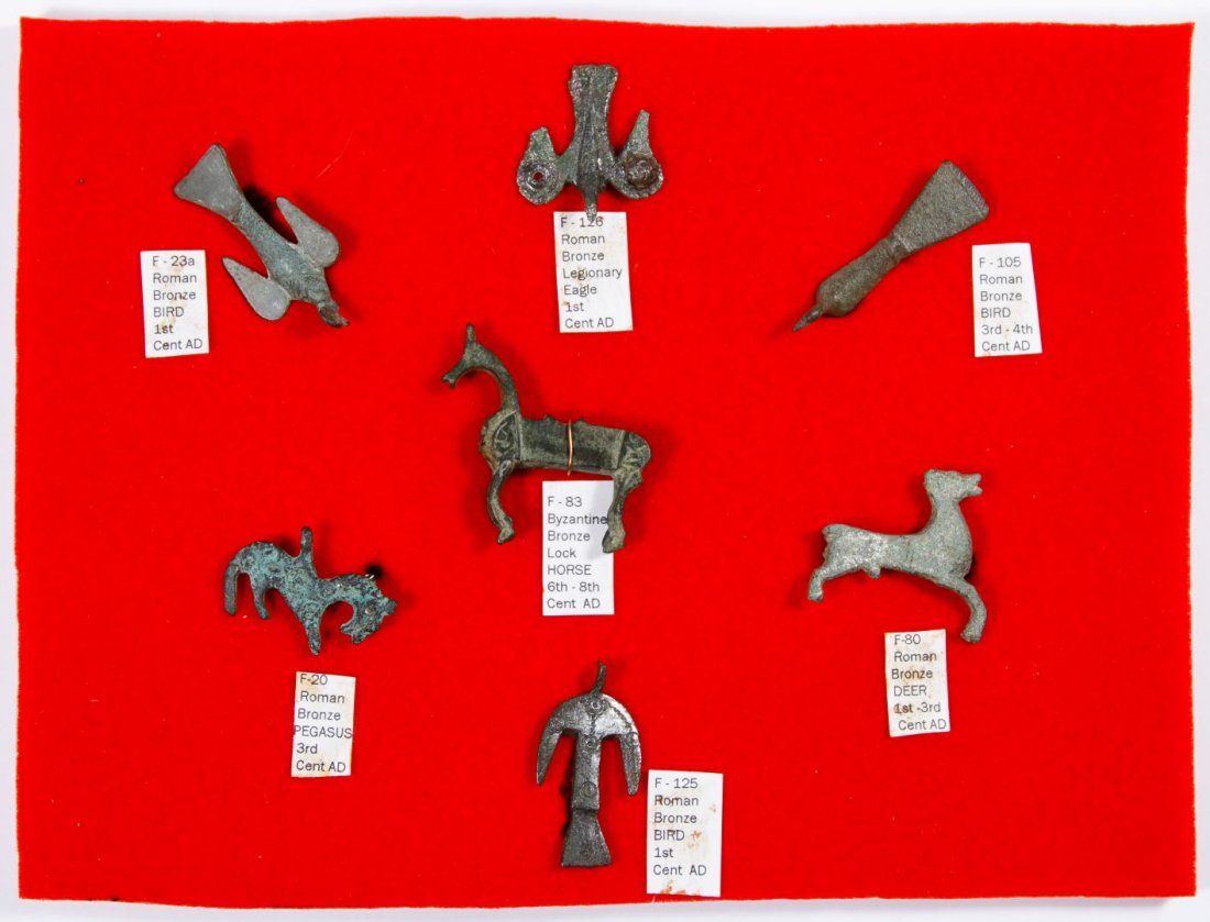 Roman / Byzantine Bronze and Silver Fibula Pin: Roman / Byzantine Bronze and Silver Fibula Pin Assortment Including seven animal figures in a case, two silver bird figures, eight loose animal figures and a bird pin mounted into a Lucite cube Height