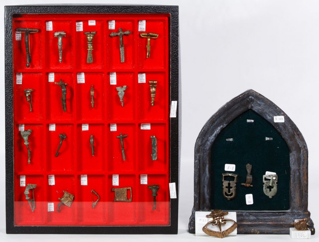 Ancient Roman Fibula Closure Pin and Belt Buckle: Ancient Roman Fibula Closure Pin and Belt Buckle Assortment Twenty-six items including brass, bronze and iron fibulae in a presentation case, and five belt buckles in a Gothic framed case Length: 2.50