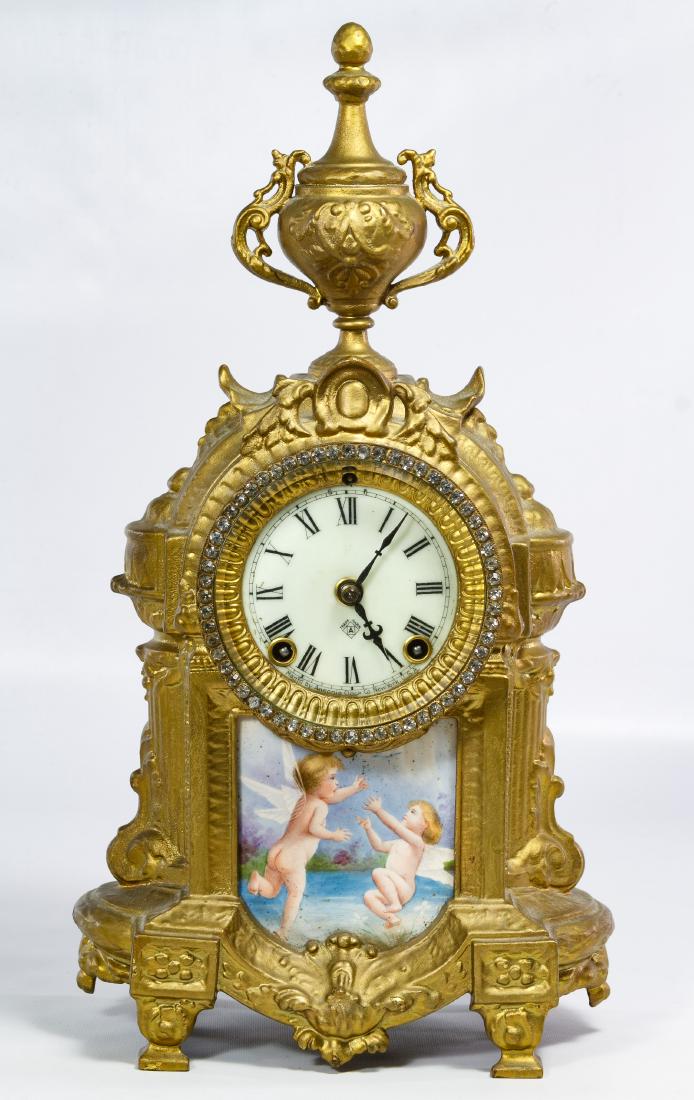 Louis XVI Style Gilt Metal Mantel Clock by Ansonia: Louis XVI Style Gilt Metal Mantel Clock by Ansonia Having an Ansonia clockworks, a German porcelain plaque insert, rhinestone bezel and gold painted metal body; with pendulum Height: 15.50 inches, Wid