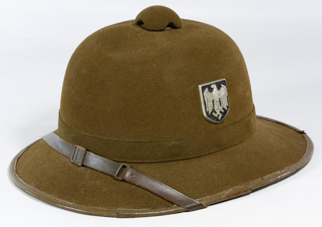 World War II German Africa Corps Pith Helmet: World War II German Africa Corps Pith Helmet Having two badges, a leather strap and a liner Length: 14.00 inches, Width: 11.00 inches Category: Military & Weapons > World War II Shipping Status: Leona