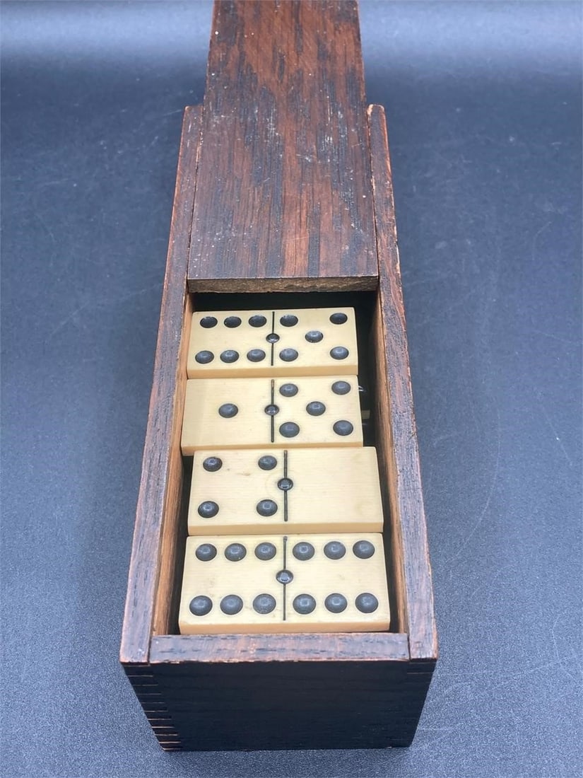 Antique Dominos Game W/ Wood Box: Antique 27 piece dominos game in wooden box. Dominos are plastic with bone and ebony look. Some dominoes have some minor wear as noted in photos, otherwise set is in good condition.