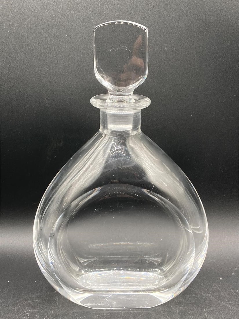 Orrefors Crystal Glass Decanter: Orrefor of Sweden crystal glass decanter with stopper. Signature noted on bottom. Decanter measures 10" tall. Area of chipped glass as noted in photos.