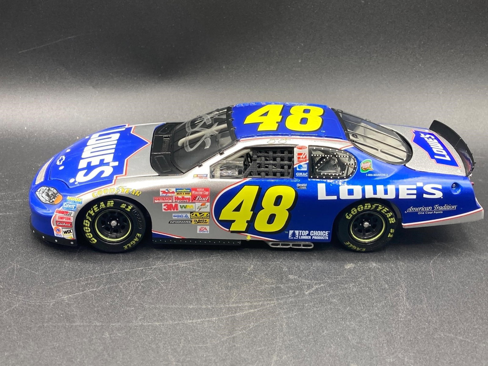 Jimmy Johnson Signed 1:24 Die Cast: Jimmy Johnson signed Action Sports 1:24 scale Lowe's #48 Chevrolet Monte Carlo die cast. Features opening hood and trunk, detailed engine bay and rubber tires. Signature on windshield noted in photos.