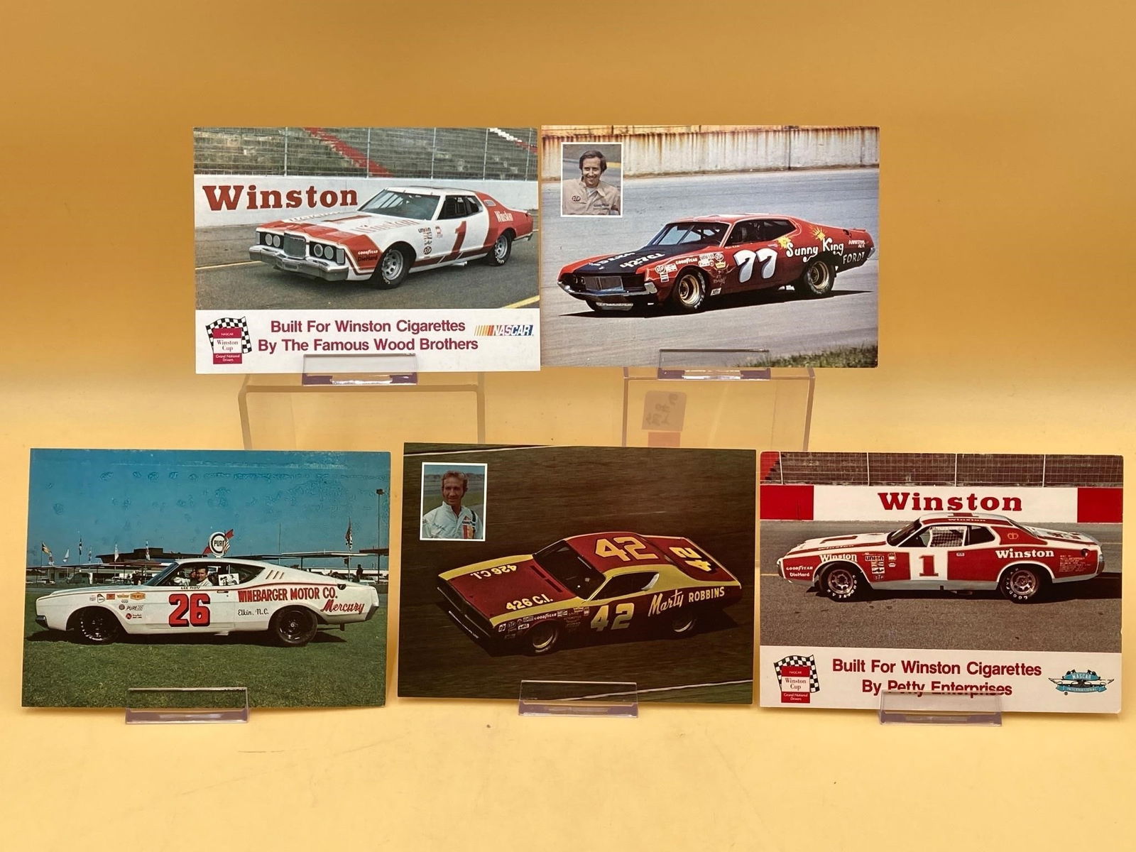 Five 1960s & 1970s Nascar Postcards: Set of five vintage 1960s & 1970s nascar postcards featuring Lee Roy Yarborough, Marty Robbins, Winston Cigarettes Dodge and Charlie Roberts cards. Cards measure 5x7". Lee Roy Yarborough card has some